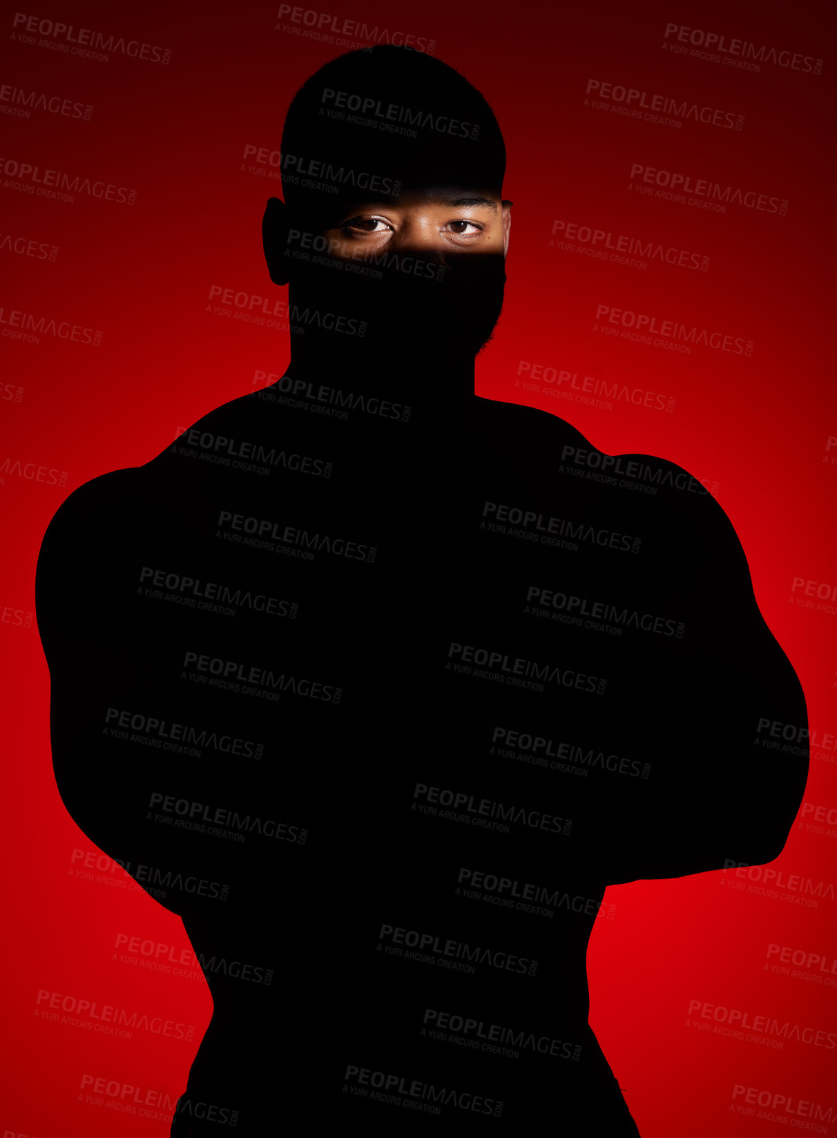 Buy stock photo Shot of an unrecognizable man standing alone and posing against a red background in the studio