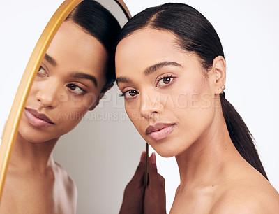 Buy stock photo Shot of a beautiful young woman posing against a mirror