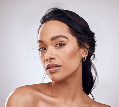 Buy stock photo Studio portrait of a beautiful young woman posing against a grey background