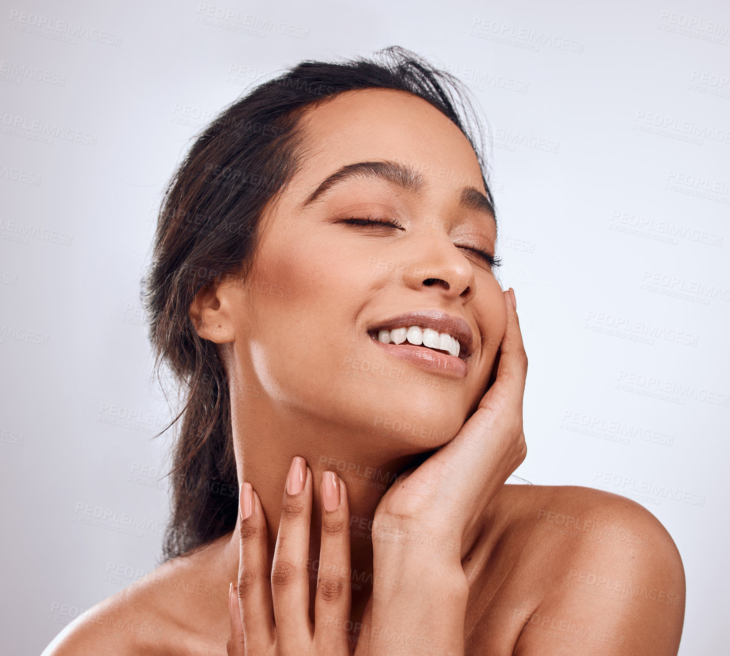 Buy stock photo Beauty, smile and hands on face of woman in studio for skincare, treatment and glowing skin on white background. Dermatology, wellness or Mexican model with cosmetic, shine and texture satisfaction