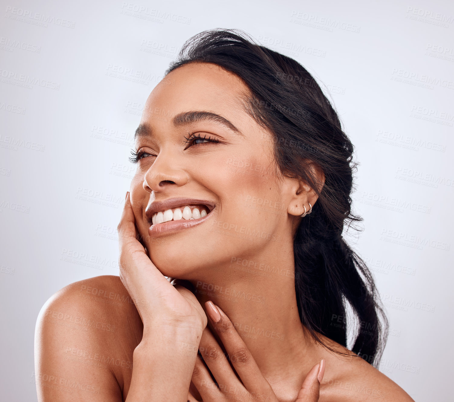 Buy stock photo Beauty, smile and hands on face of girl in studio for skincare, treatment and glowing skin on white background. Dermatology, wellness or Mexican model with cosmetic, shine and texture satisfaction