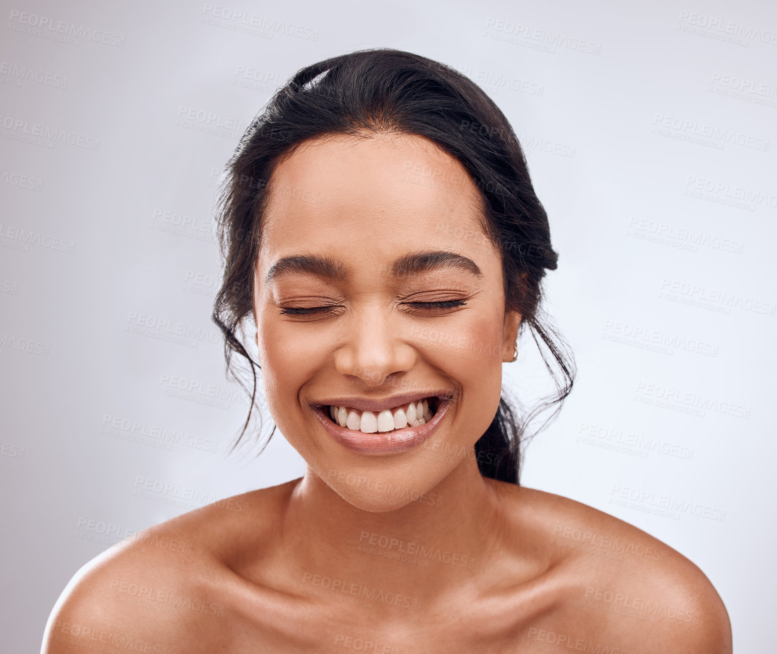 Buy stock photo Studio shot of a beautiful young woman posing against a grey background