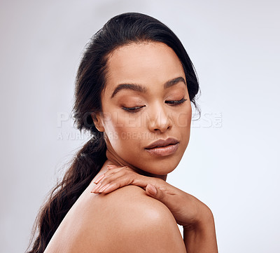 Buy stock photo Studio shot of a beautiful young woman posing against a grey background