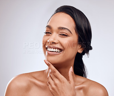 Buy stock photo Studio portrait of a beautiful young woman posing against a grey background