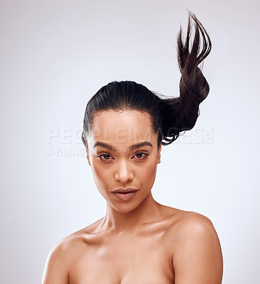 Buy stock photo Studio portrait of a beautiful young woman posing against a grey background