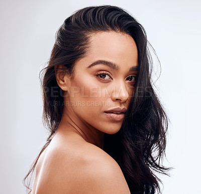 Buy stock photo Studio portrait of a beautiful young woman posing against a grey background