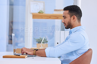 Buy stock photo Shot of a businessman typing on his laptop