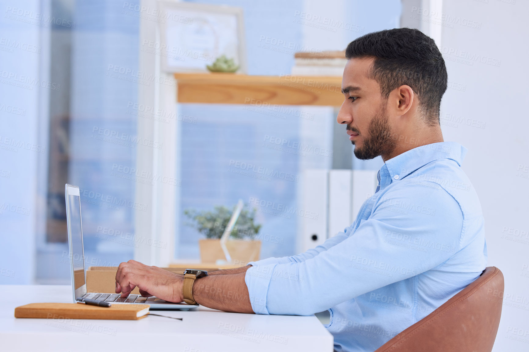 Buy stock photo Shot of a businessman typing on his laptop