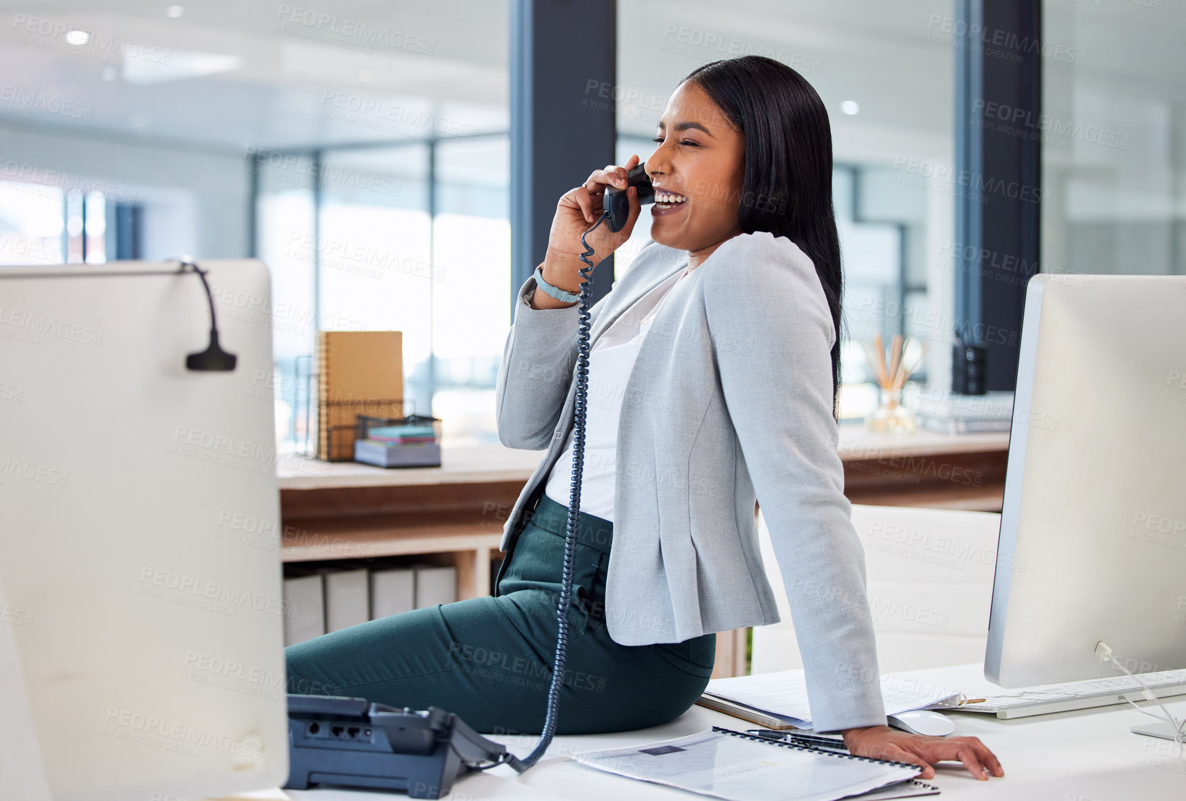 Buy stock photo Shot of an attractive young businesswoman sitting alone in her office and using a telephone