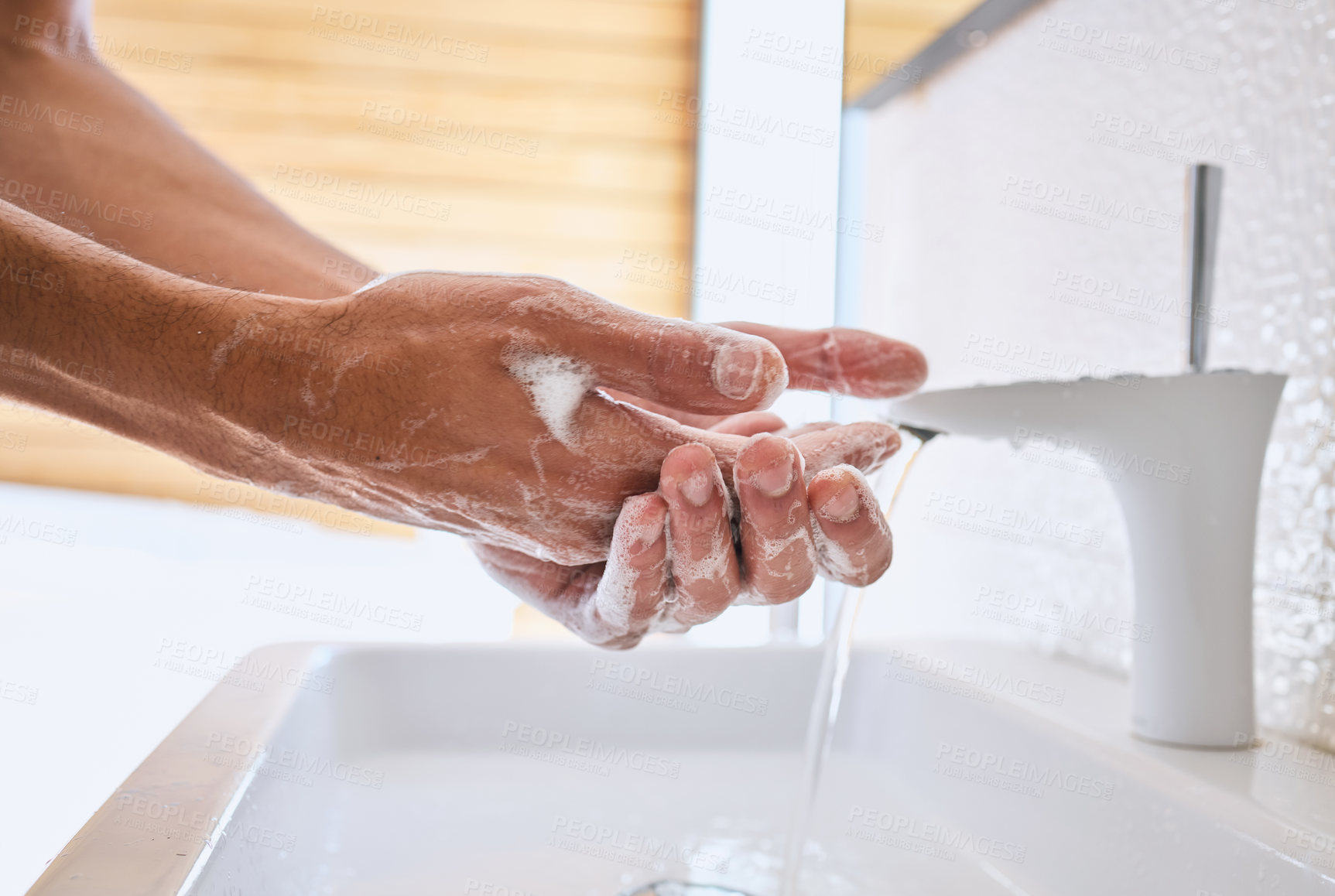 Buy stock photo Shot of an unrecognizable man washing his hands in a bathroom at home