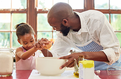 Buy stock photo Shot of an adorable little girl and her father bonding by baking in the kitchen at home