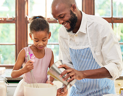 Buy stock photo Shot of an adorable little girl and her father bonding by baking in the kitchen at home