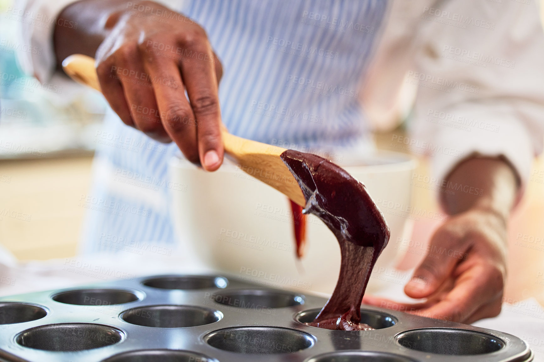 Buy stock photo Cupcake, chocolate and hands of a person baking in a kitchen and cooking dessert recipe in the morning. Restaurant, man and professional chef preparing to bake in a muffin or culinary tray at bakery