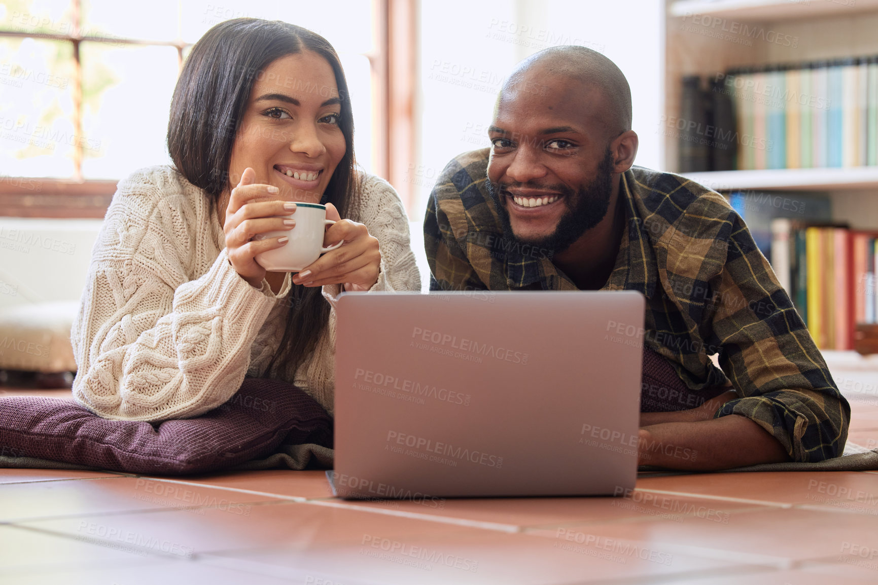 Buy stock photo Shot of a young couple spending quality time together while watching a movie on a laptop at home
