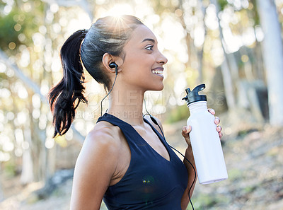 Buy stock photo Fitness, water bottle and woman running outdoor for race, competition or marathon training. Sports, nature and female athlete runner drinking a liquid during a cardio exercise or workout in the woods