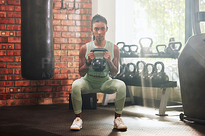Buy stock photo Fitness, kettlebell and portrait of a woman in the gym doing strength legs and arms training. Sports, exercise and serious female athlete doing a strong squat workout with a weight in a sport center.