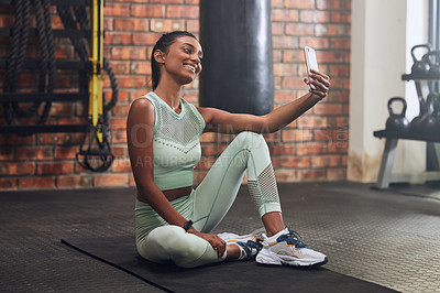 Buy stock photo Gym, fitness or happy woman taking selfie on workout, exercise or training break for social media. Wellness, smile or healthy Indian girl smiling, relaxing or taking pictures for online post