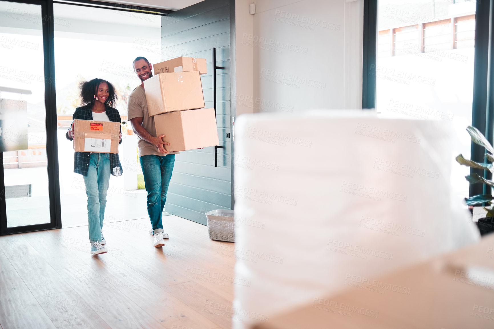 Buy stock photo Shot of a little girl and her father moving into their new home