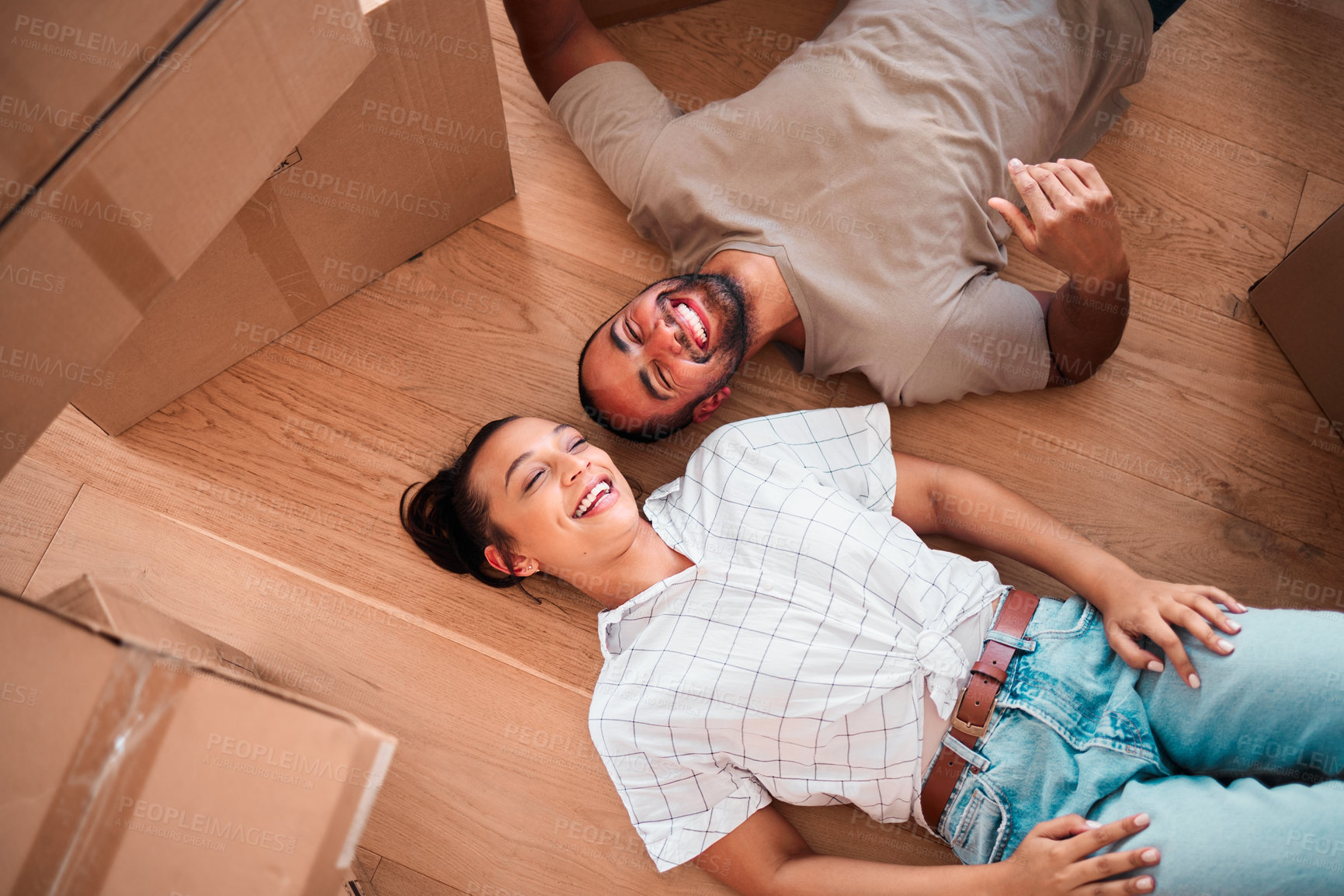 Buy stock photo Top view, happy couple and moving into new home on floor, ground and relax from packing boxes. Man, woman and taking a break in house from property mortgage, real estate and investment of apartment