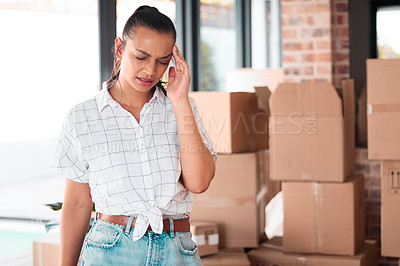 Buy stock photo Headache, box and woman with pain in new house, apartment or property for moving, relocating or purchase a home. Stress, real estate or mortgage for renovation with anxiety in space, lounge or room
