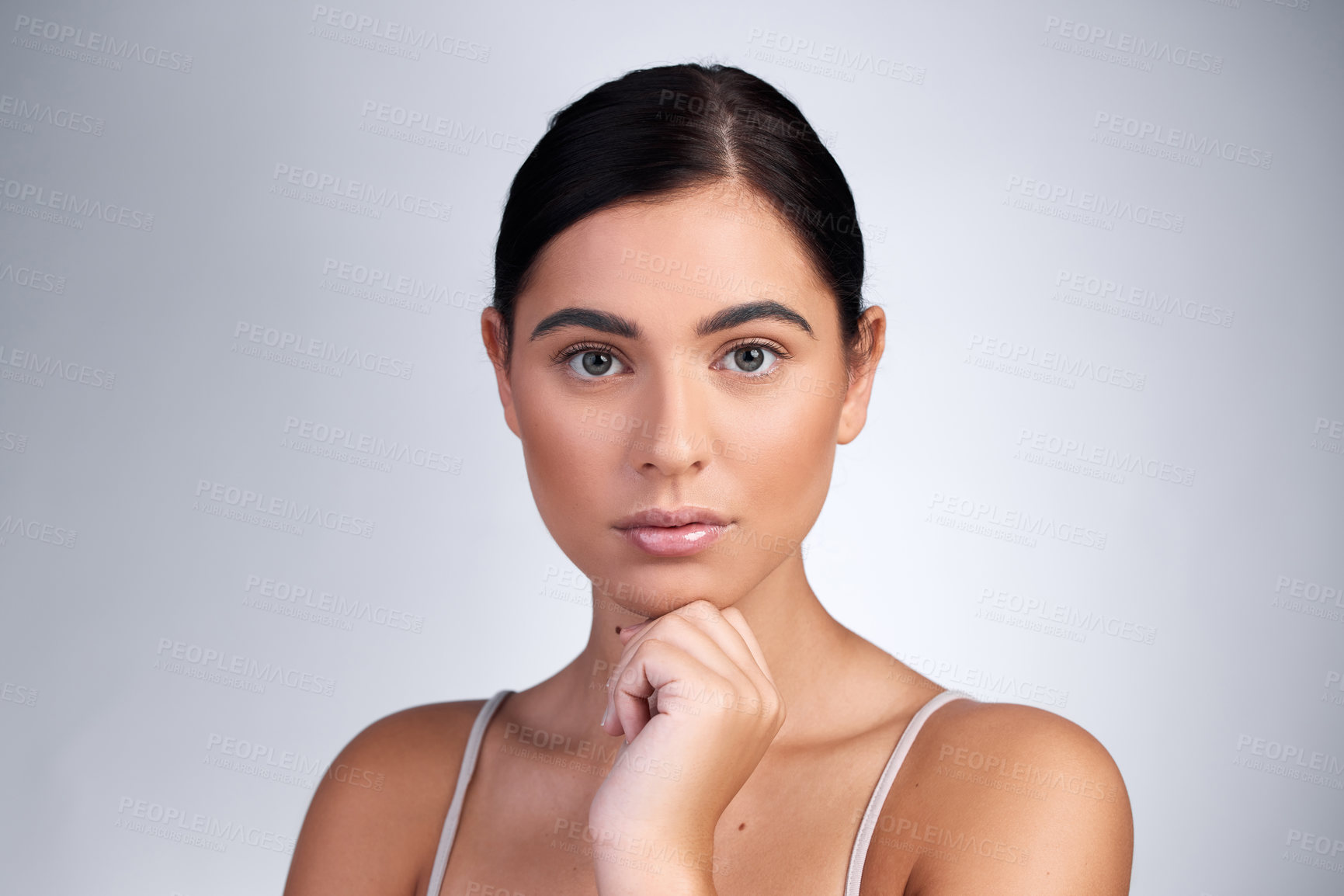 Buy stock photo Studio shot of a beautiful young woman posing against a grey background