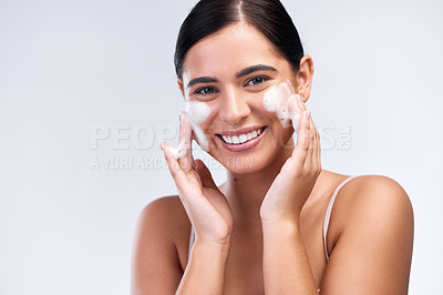 Buy stock photo Beauty, foam wash and portrait of a woman in a studio for natural, cosmetic and skincare routine. Wellness, smile and female model cleaning her face with facial cleanser isolated by white background