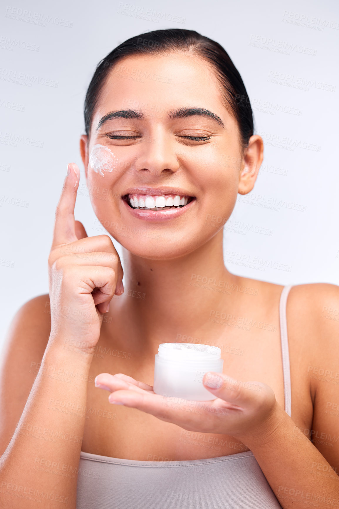 Buy stock photo Woman, container and apply lotion in studio, hydration and beauty or cosmetics on white background. Happy female person, cream and facial treatment in jar, moisturizer and skincare for smooth skin