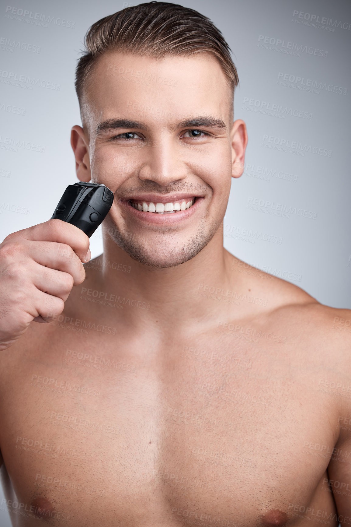 Buy stock photo Portrait, shave and machine with man in studio, skincare and hygiene for facial grooming. Cosmetic, hair removal and wellness for dermatology, maintenance and electric cleaning tool for body