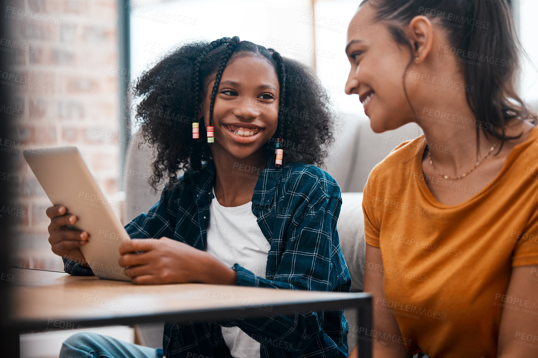 Buy stock photo Girl, smile and mother with tablet at house for acceptance at private school, scholarship and education. Happy, woman and child on sofa with positive news, email and online learning for knowledge