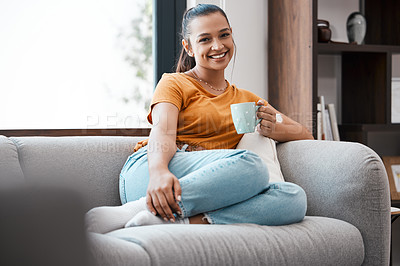 Buy stock photo Shot of a young woman relaxing on the couch at home