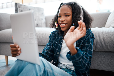 Buy stock photo Shot of a young girl using a digital tablet at home