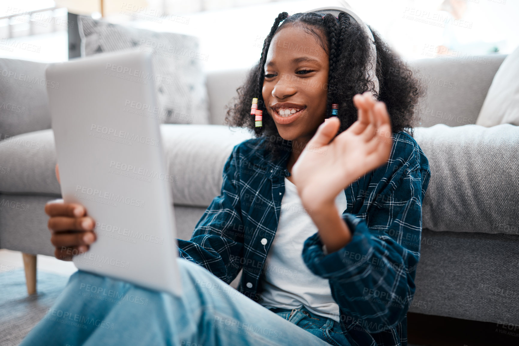 Buy stock photo Shot of a young girl using a digital tablet at home