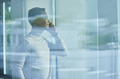 Buy stock photo Shot of a young man on call at home