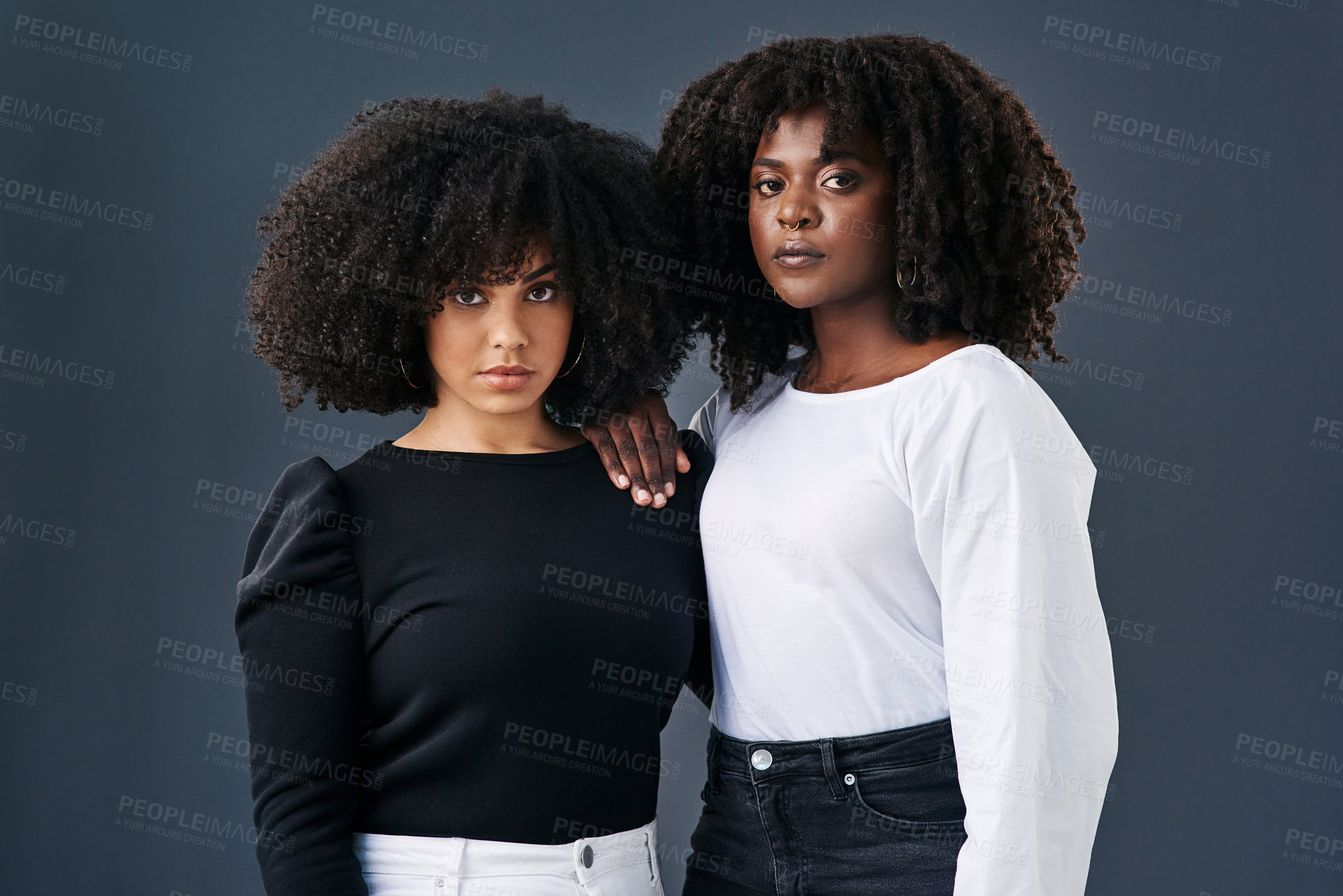 Buy stock photo Two businesswomen together against a studio background