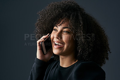 Buy stock photo Shot of a young businesswoman using her smartphone against a studio background