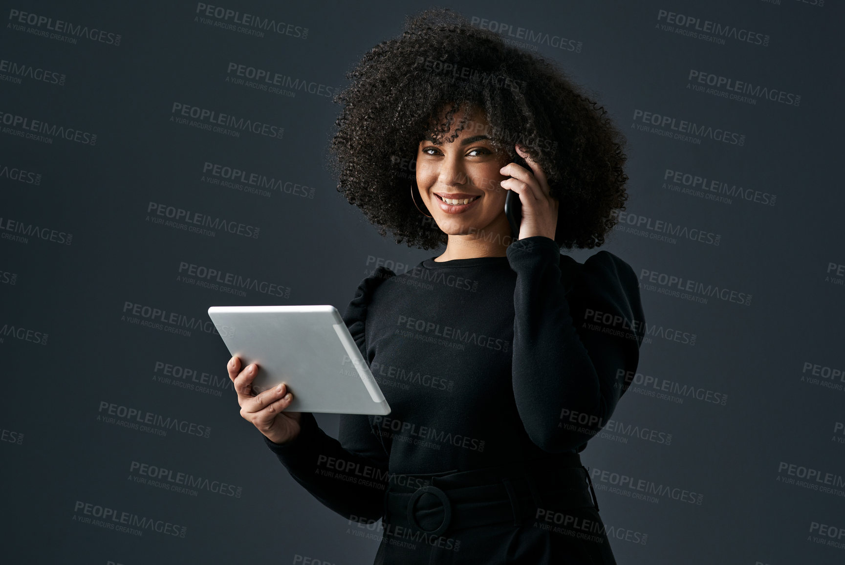 Buy stock photo Shot of a young businesswoman using a digital tablet against a studio background