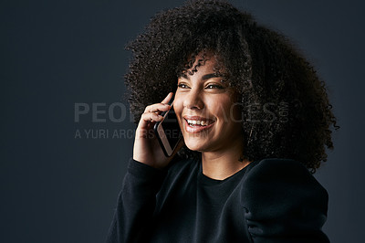 Buy stock photo Shot of a young businesswoman using her smartphone against a studio background