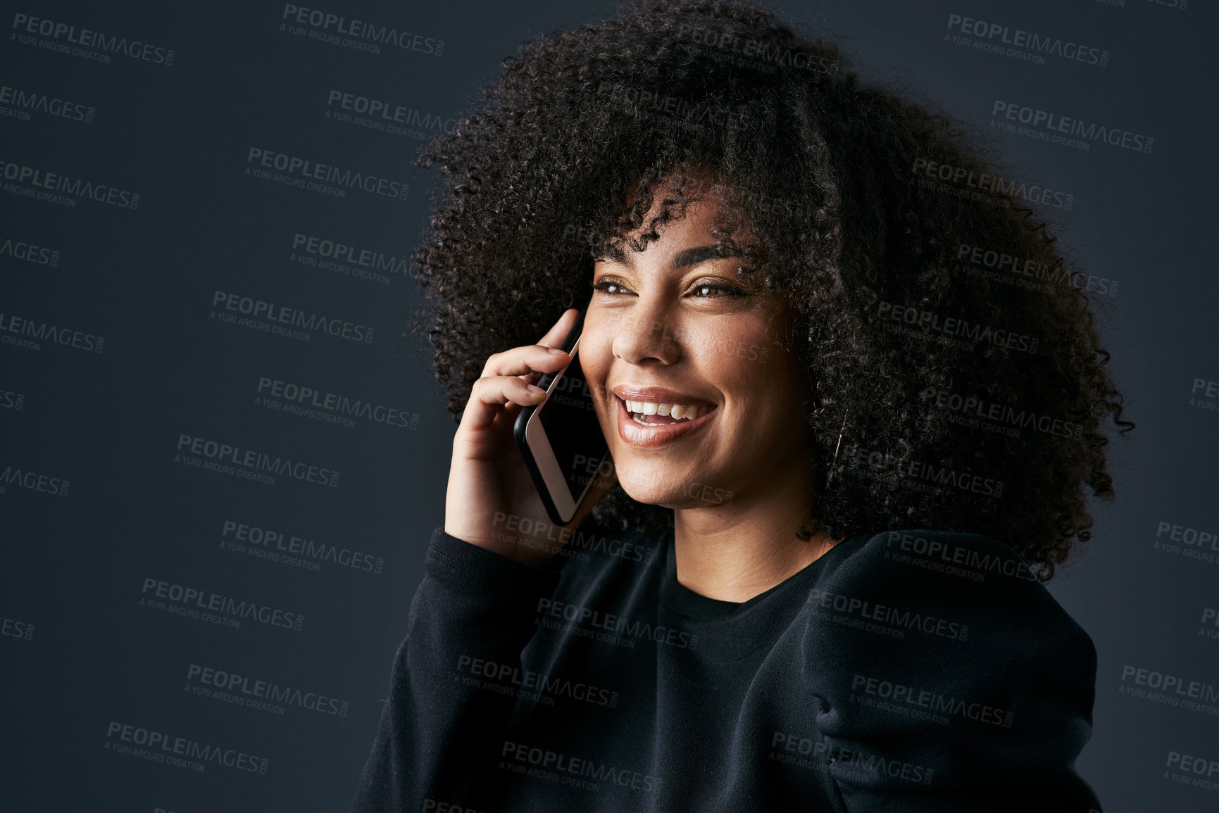 Buy stock photo Shot of a young businesswoman using her smartphone against a studio background