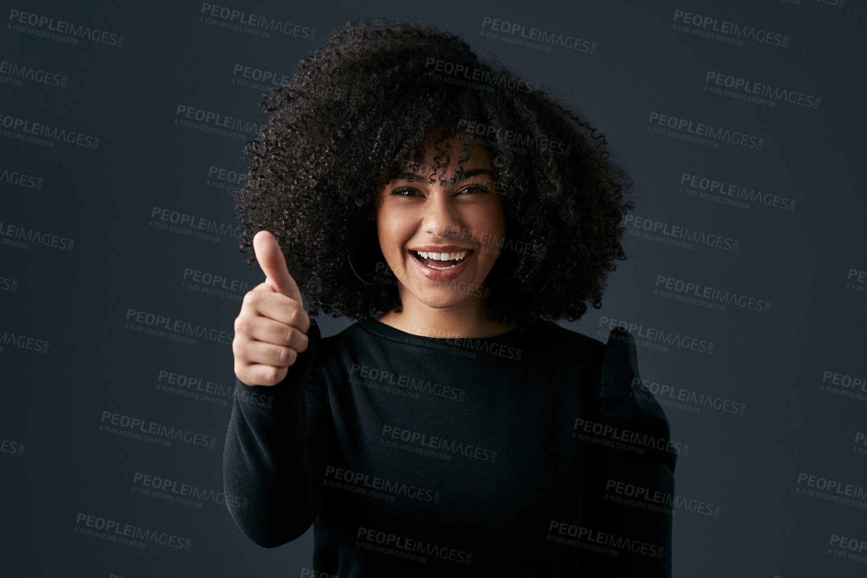 Buy stock photo Shot of a young businesswoman giving the thumbs up against a studio background
