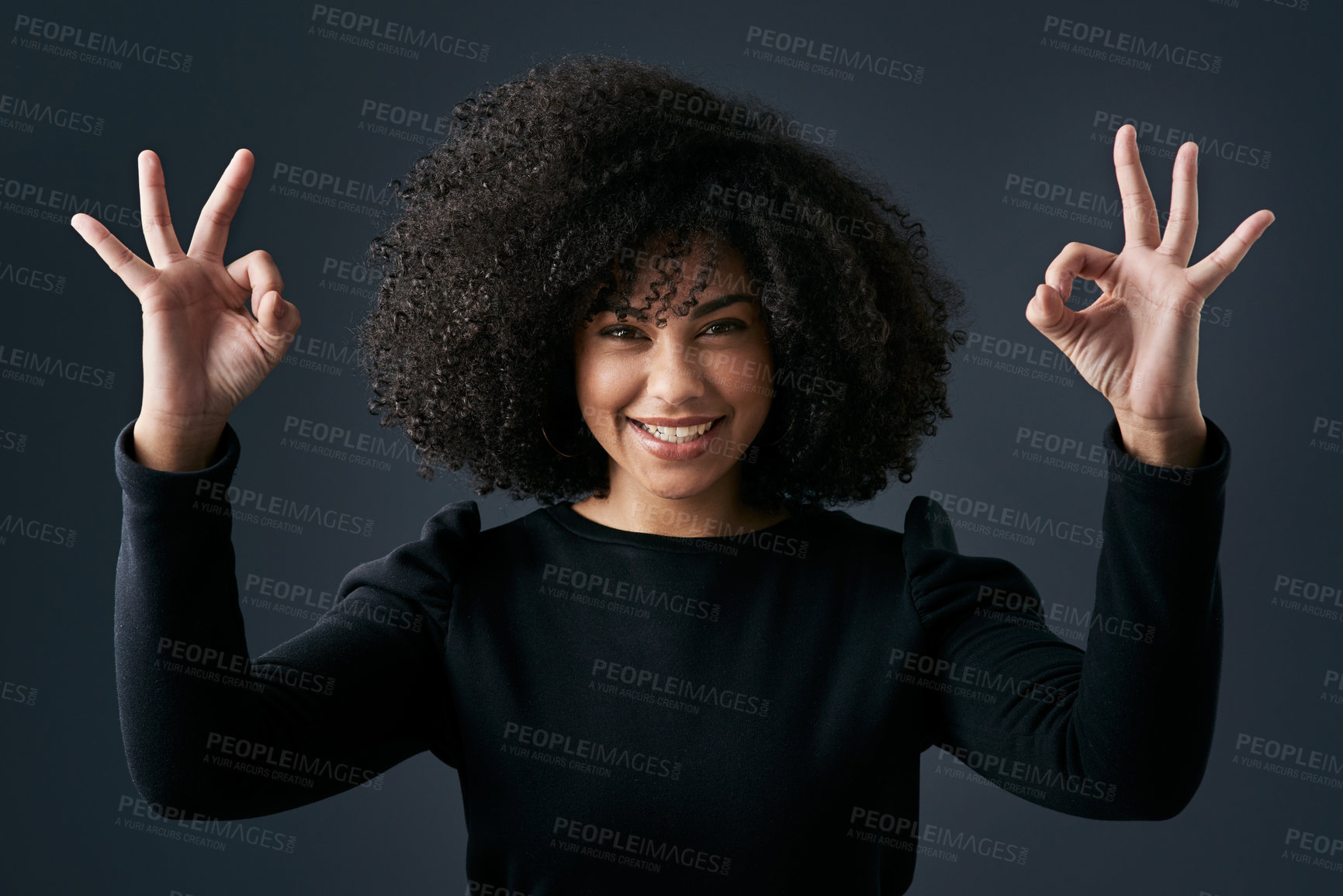 Buy stock photo Shot of a young businesswoman making hand gestures against a studio background