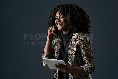 Buy stock photo Shot of a young businesswoman using a digital tablet against a studio background