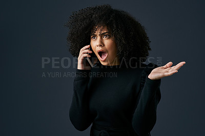 Buy stock photo Shot of a young businesswoman using her smartphone against a studio background