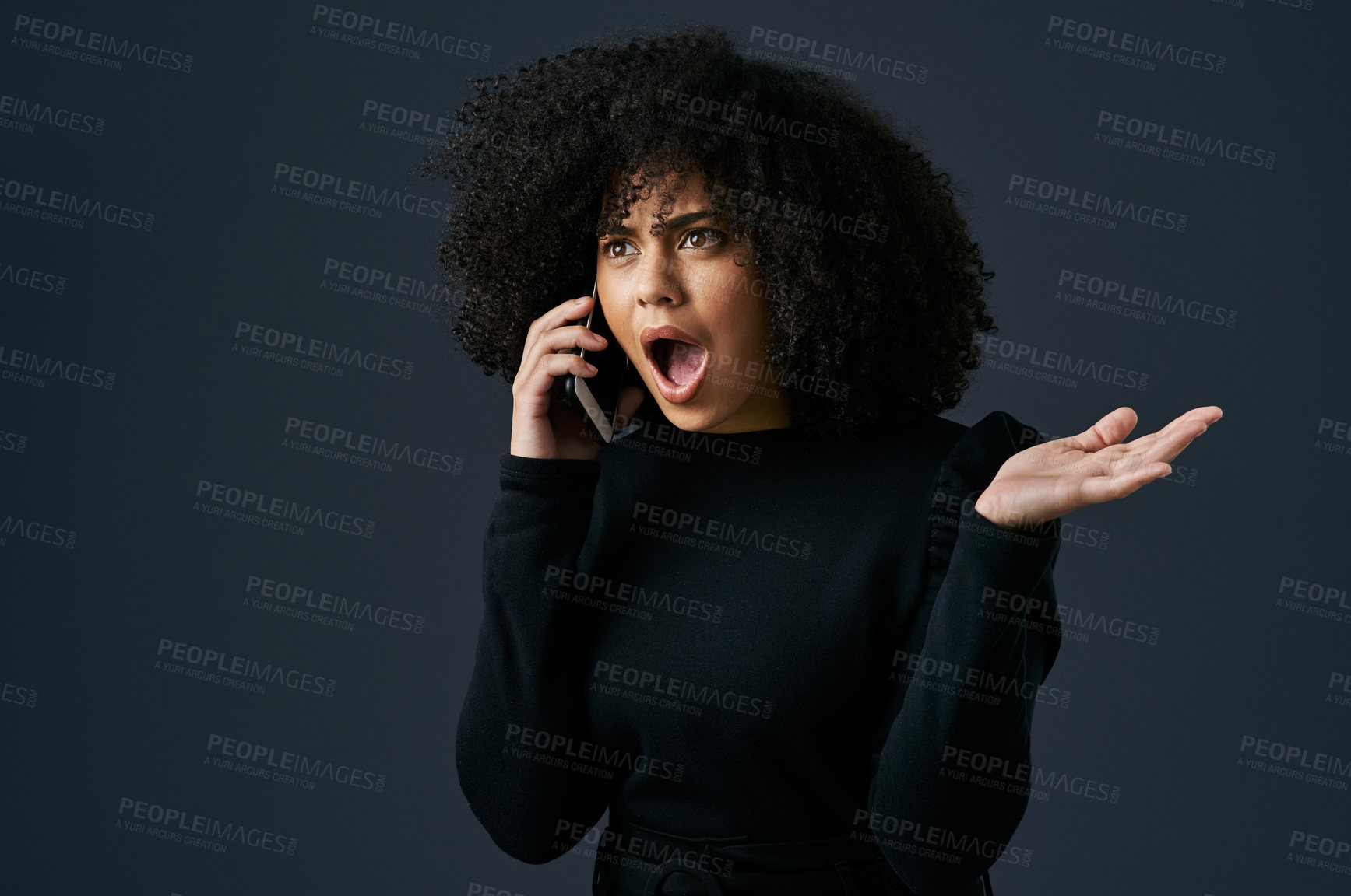 Buy stock photo Shot of a young businesswoman using her smartphone against a studio background