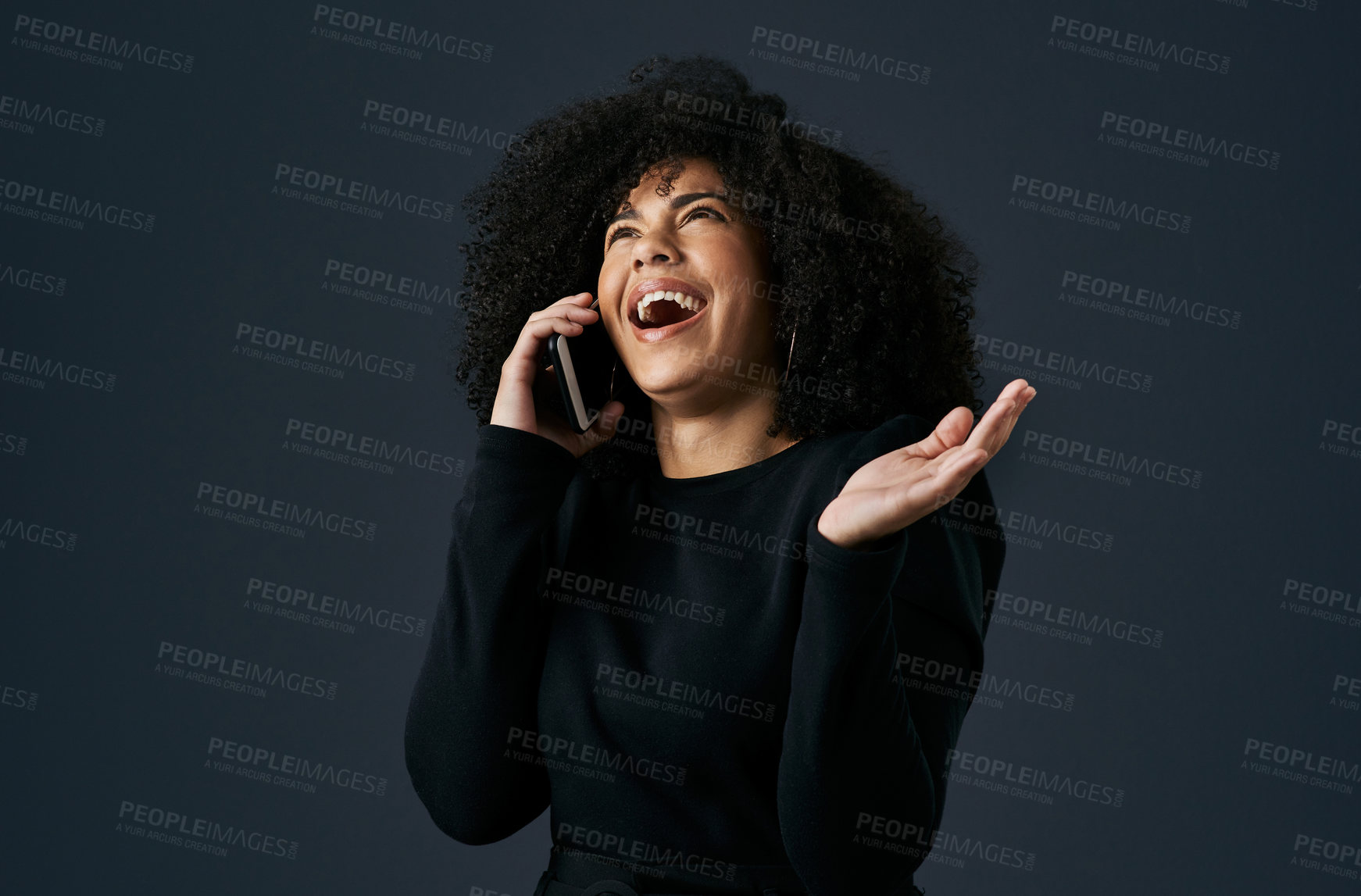 Buy stock photo Shot of a young businesswoman using her smartphone against a studio background