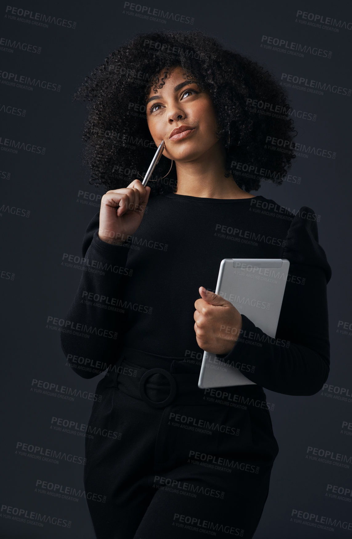 Buy stock photo Shot of a young businesswoman using a digital tablet against a studio background