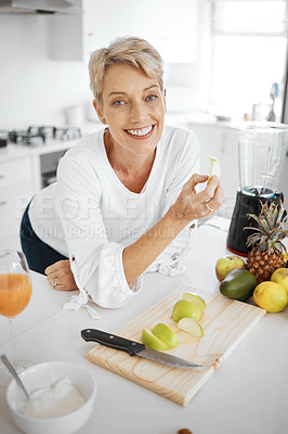 Buy stock photo Portrait, fruit salad and apple with an old woman in the kitchen of her home for health, diet or nutrition. Smile, food and cooking with a happy mature female pensioner eating healthy in the house
