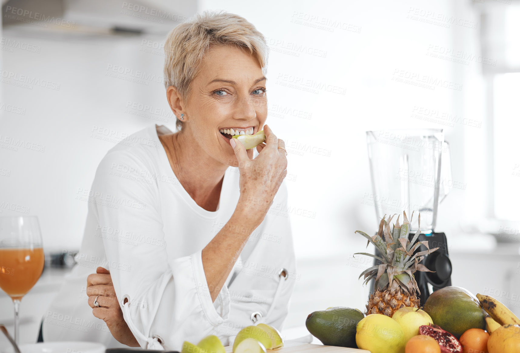 Buy stock photo Portrait, fruit salad and apple with an elderly woman in the kitchen of her home for health, diet or nutrition. Smile, food and cooking with a happy senior female pensioner eating healthy in a house