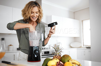 Buy stock photo Mature woman, blender and smoothie in kitchen with smile for nutrition, wellness and meal prep in home. Person, fruit and juicer for drink, detox and gut health with ingredients in morning at house