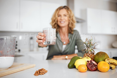 Buy stock photo Shot of a woman about to drink a glass of smoothie