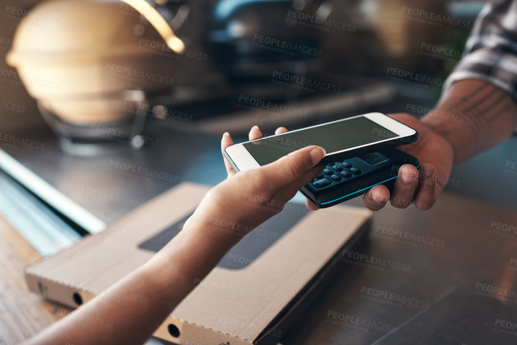 Buy stock photo Cropped shot of an unrecognizable woman standing and using her cellphone to pay for her meal at a restaurant